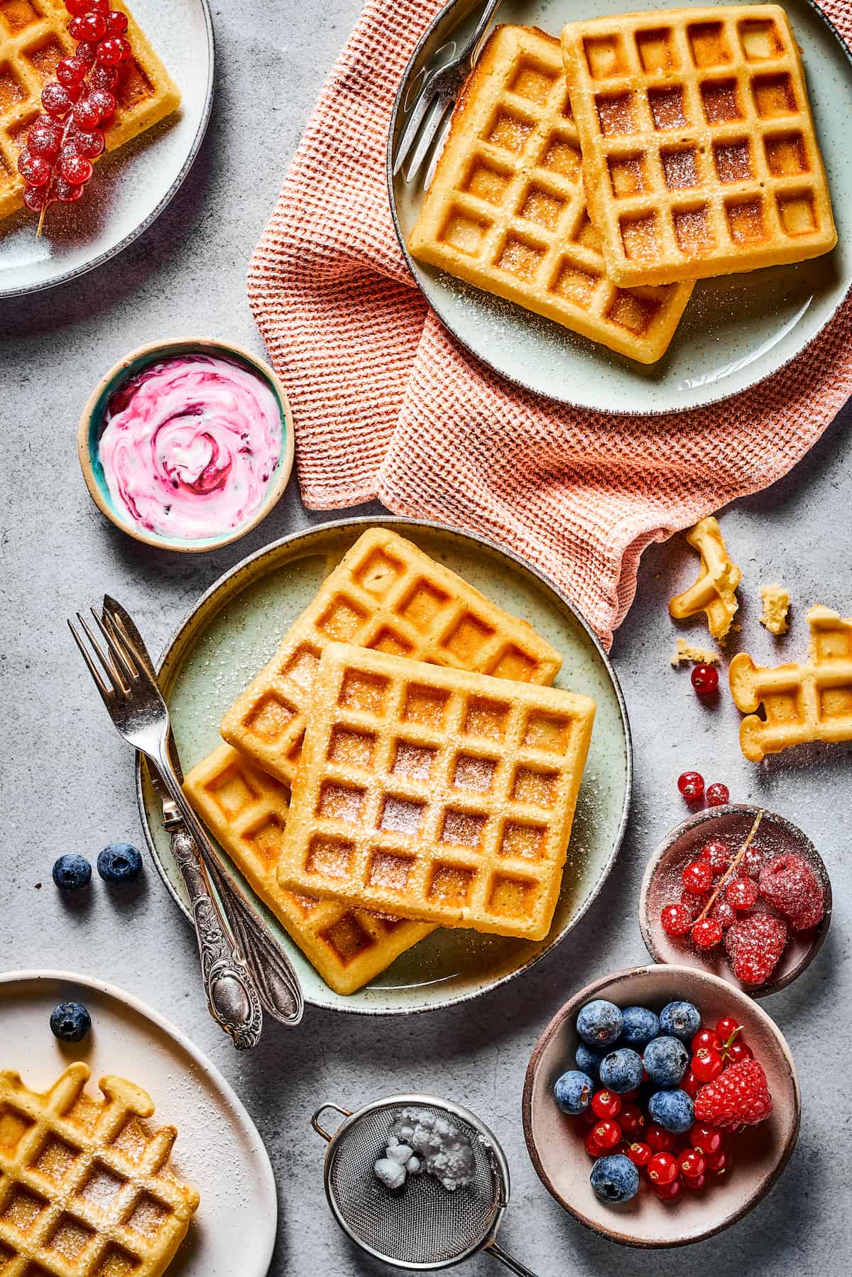 A tablescape with fresh fruit, homemade waffle recipe, and cloth napkins.