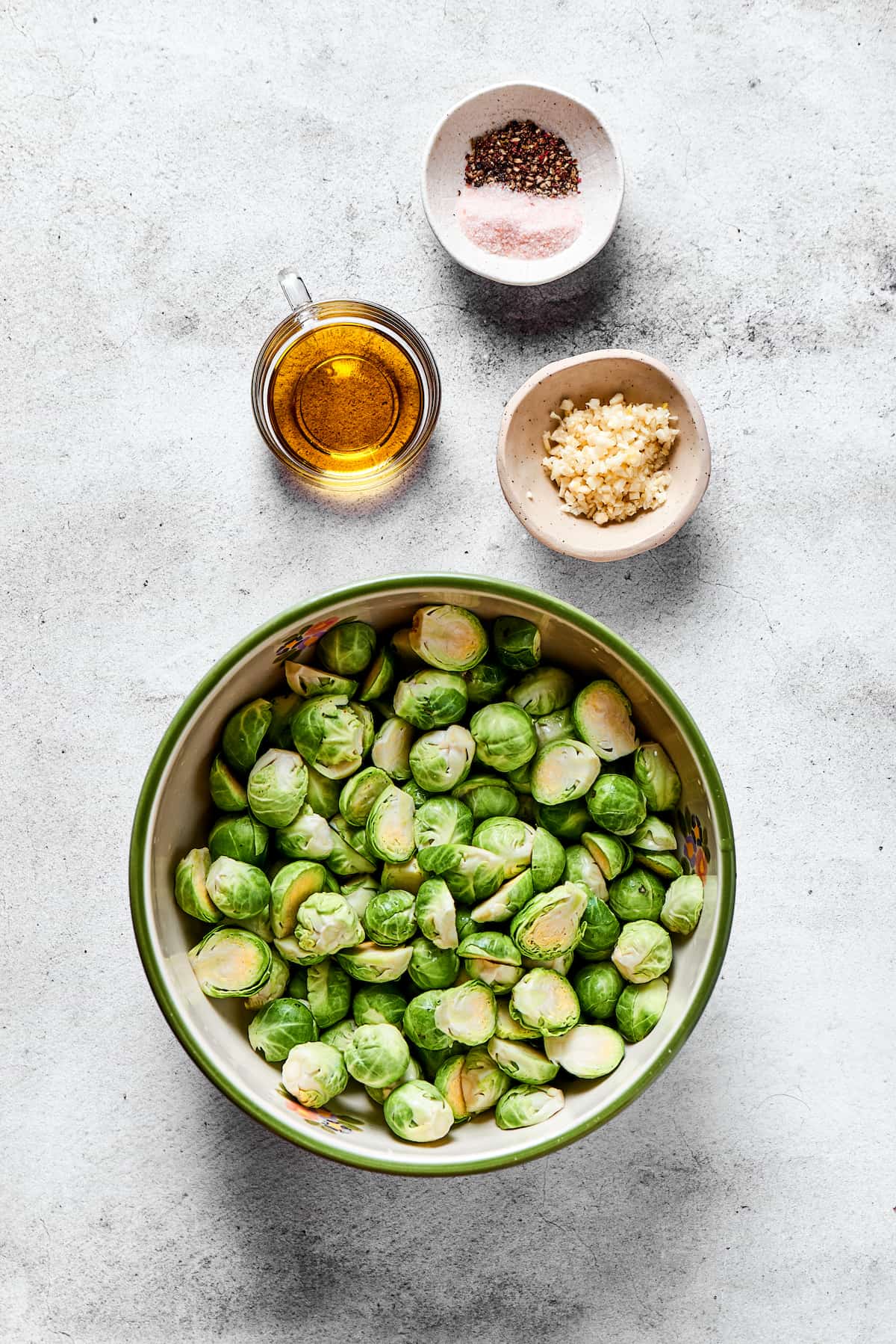 From top: Salt and pepper, olive oil, garlic, brussels sprouts.
