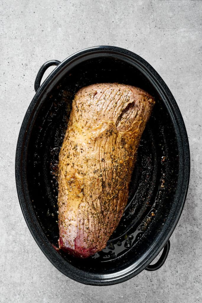 A rump roast browning in a Dutch oven.