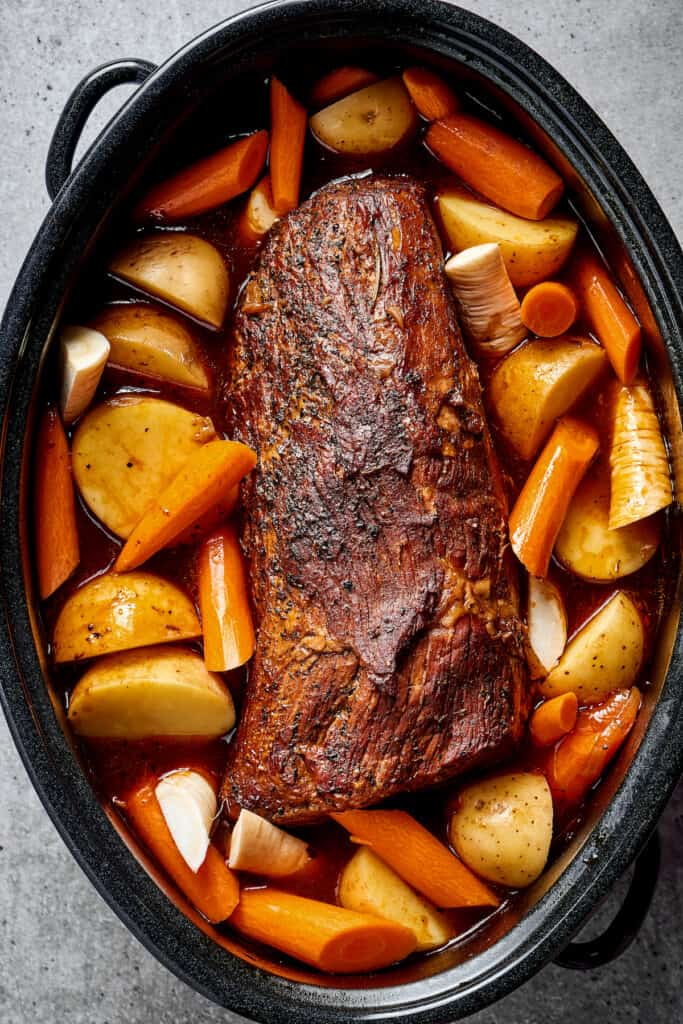 Pot roast with vegetables in a Dutch oven.