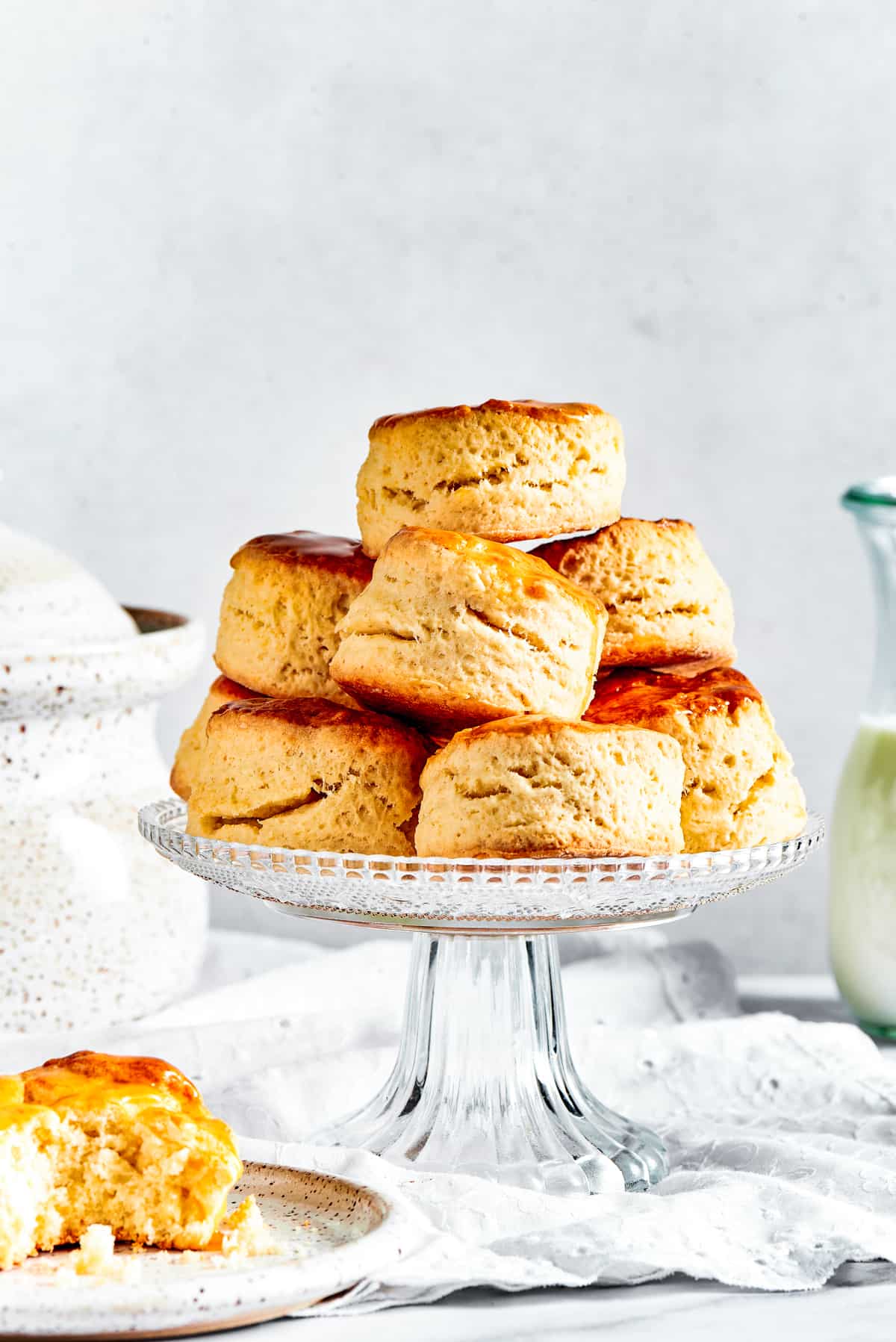 Biscuits on a cake stand, with one biscuit placed on a saucer.