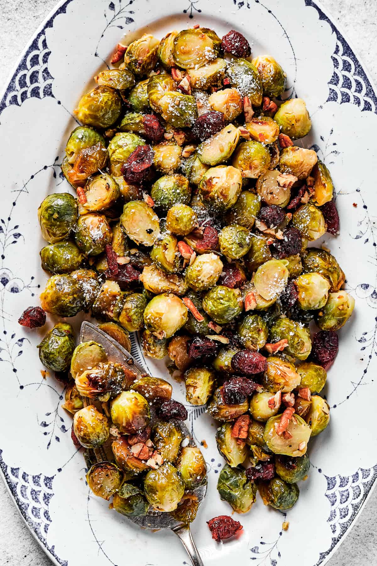 Close-up shot of glazed brussel sprouts with cranberries and pecans.