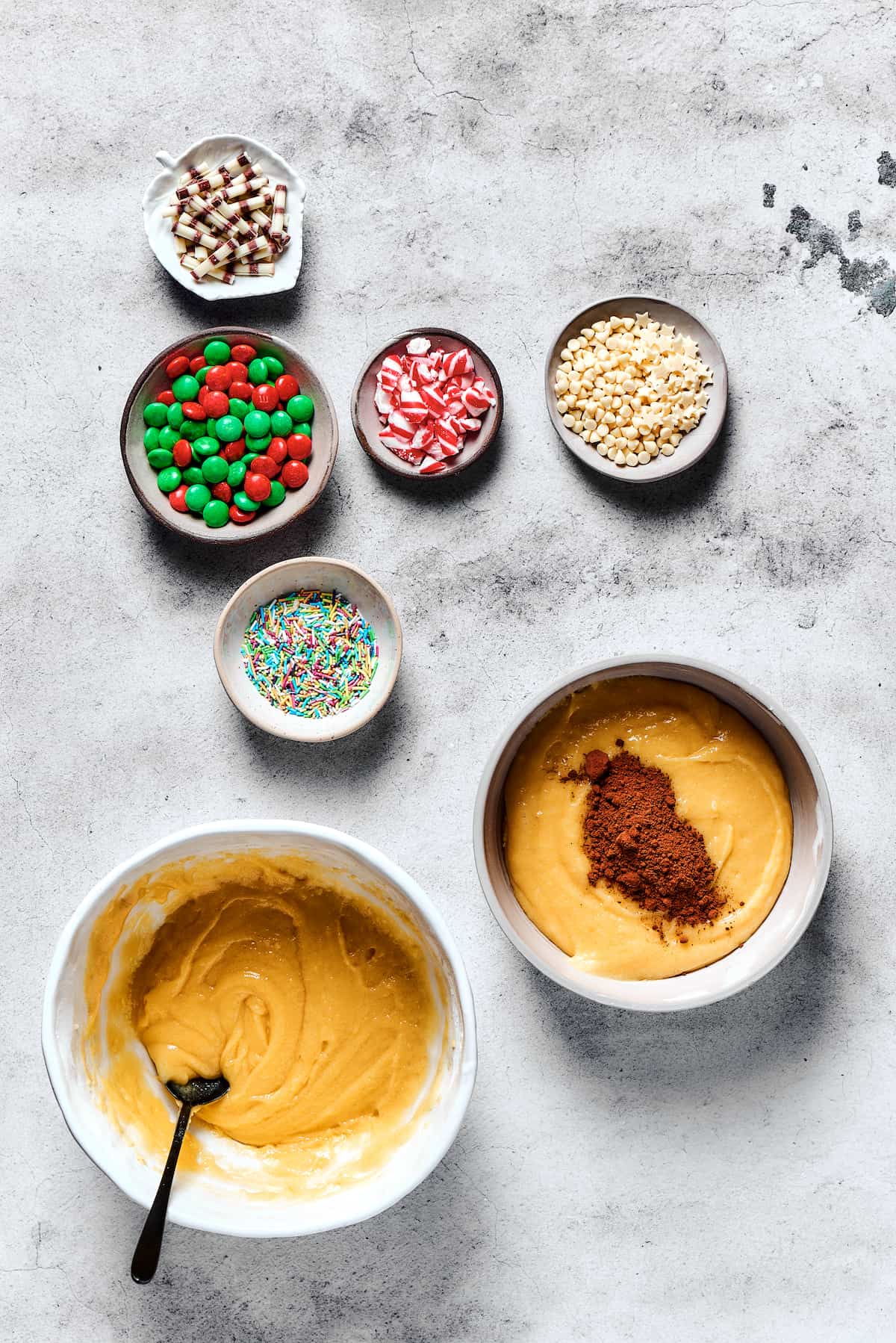 Adding cocoa powder to one bowl of cookie dough.