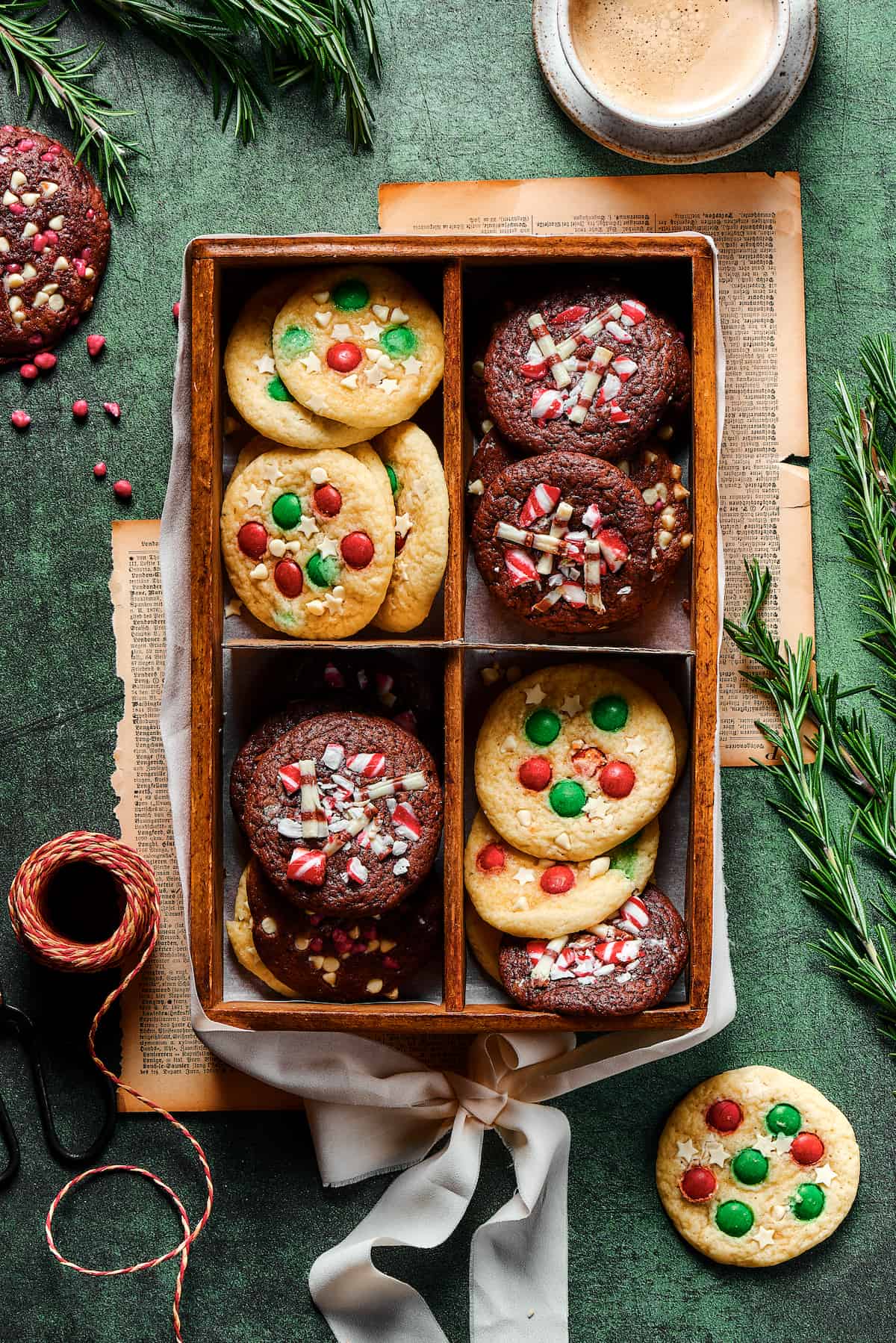 A box divided into four. Each section of the box has several Christmas cookies in it.