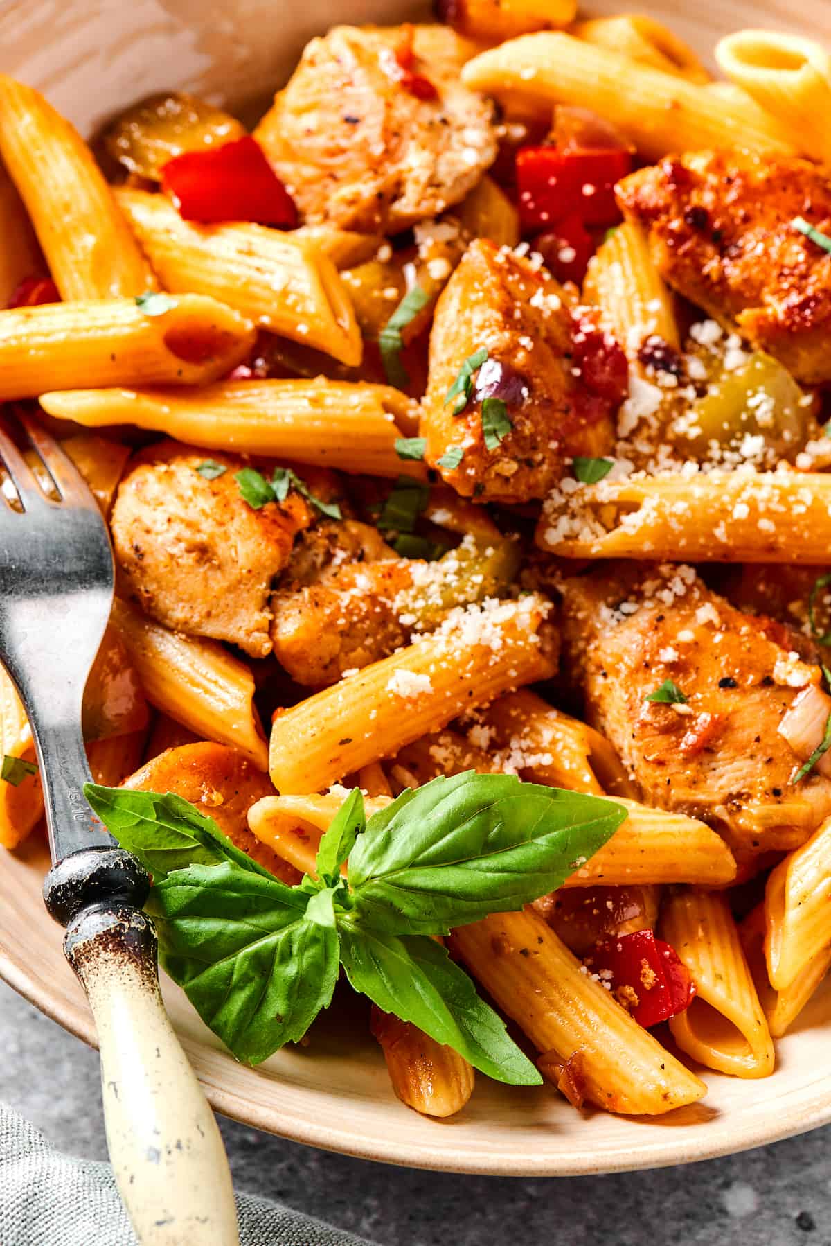 Chicken and penne with tomatoes, peppers, and onions.