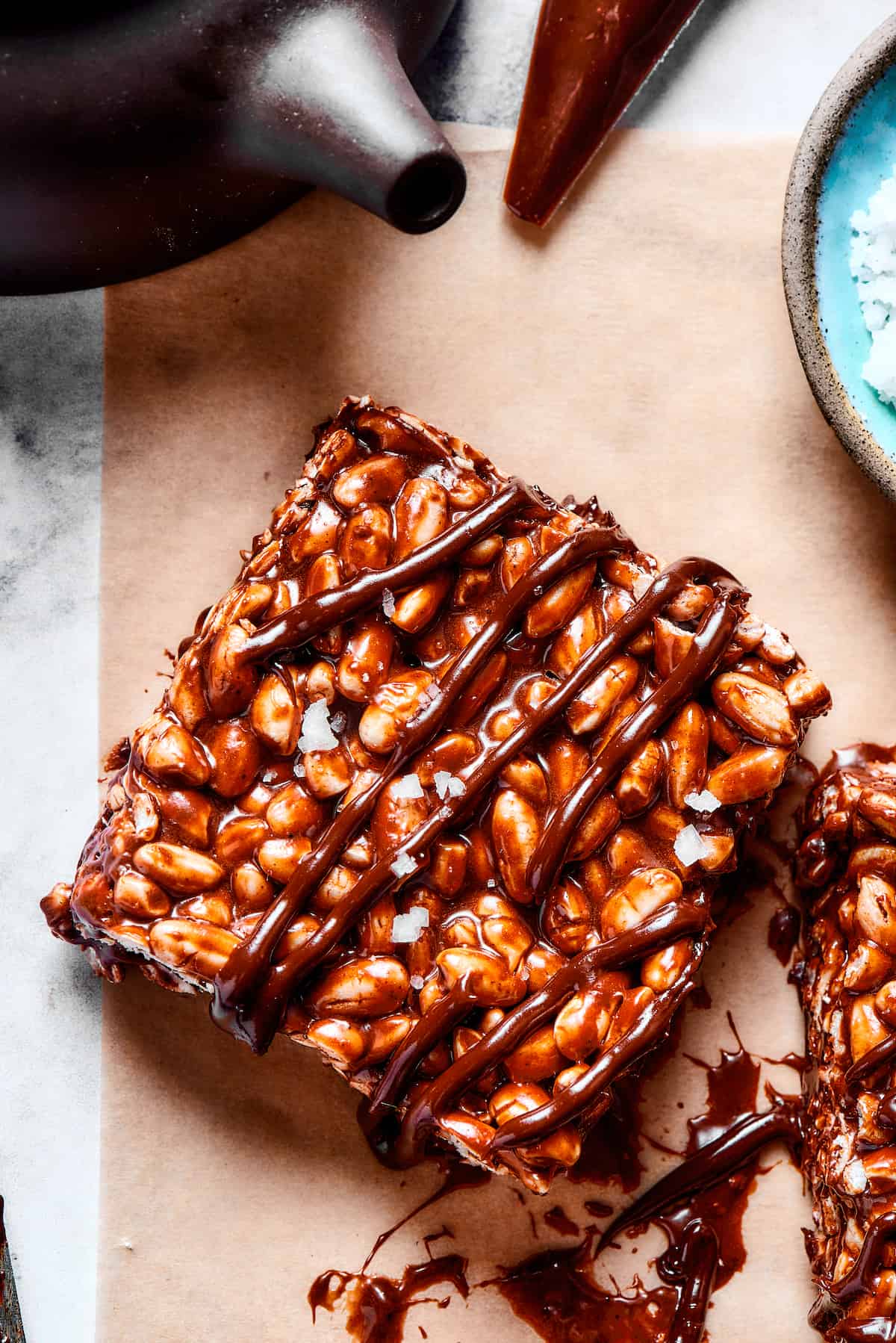 A chocolate rice and marshmallow square with chocolate drizzle.