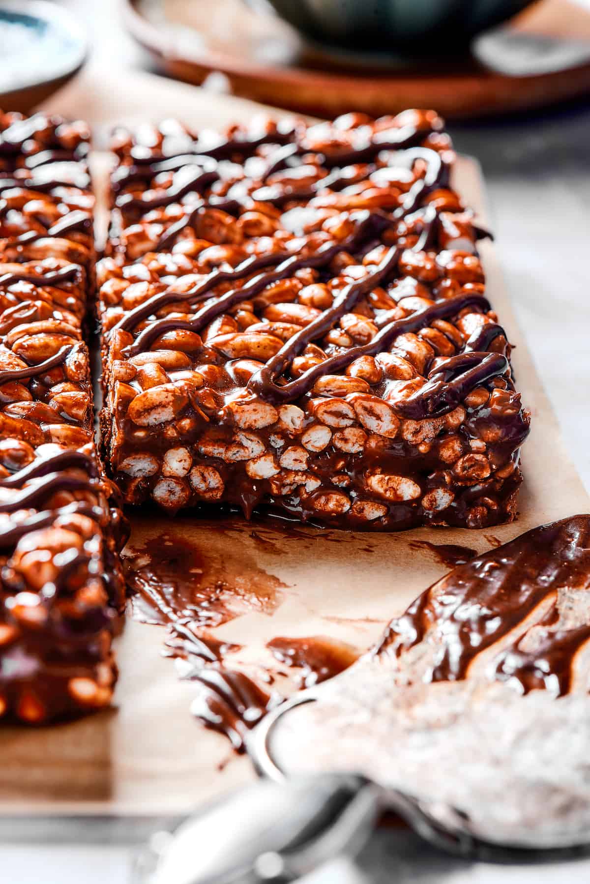 Squares of chocolate cereal bar with chocolate and marshmallow topping.