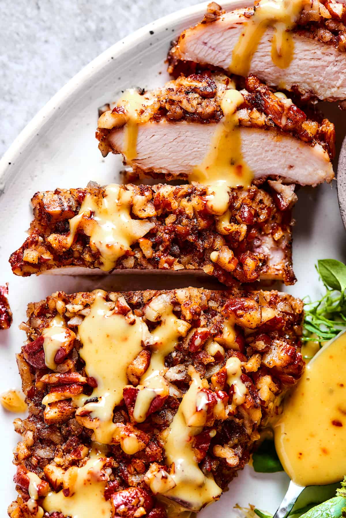 Close-up shot of sliced pecan crusted chicken.