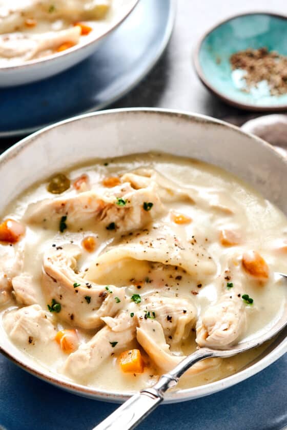Creamy chicken and dumplings served into bowls.