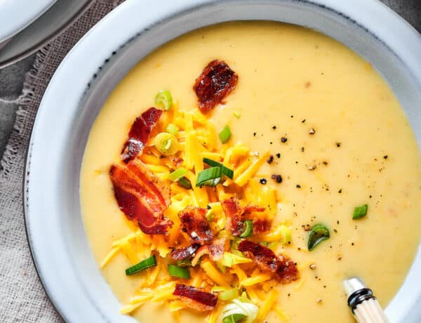 Baked potato soup topped with bacon, cheese, and chopped green onion.