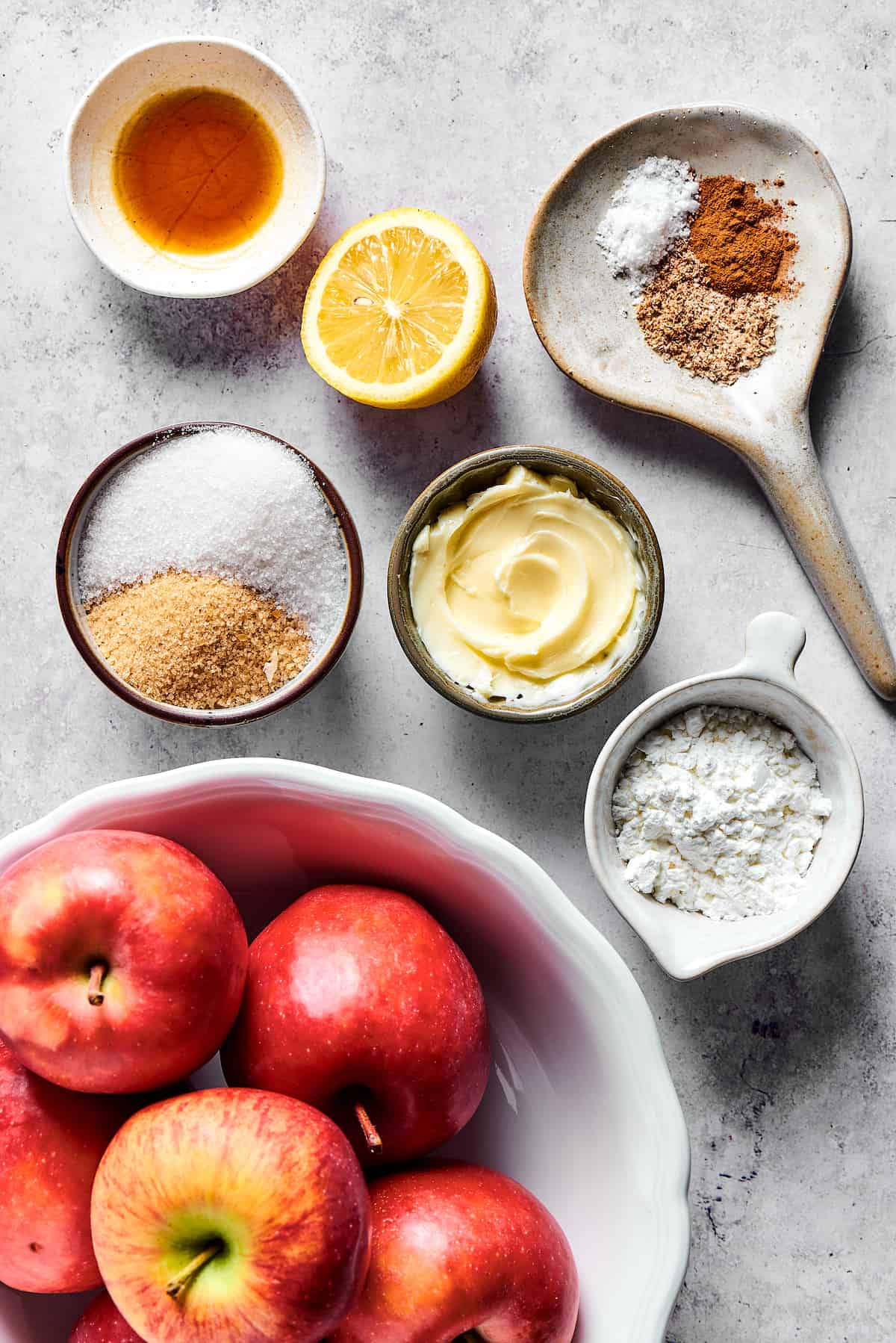 Apple filling ingredients measured into small dishes and arranged on a work surface.