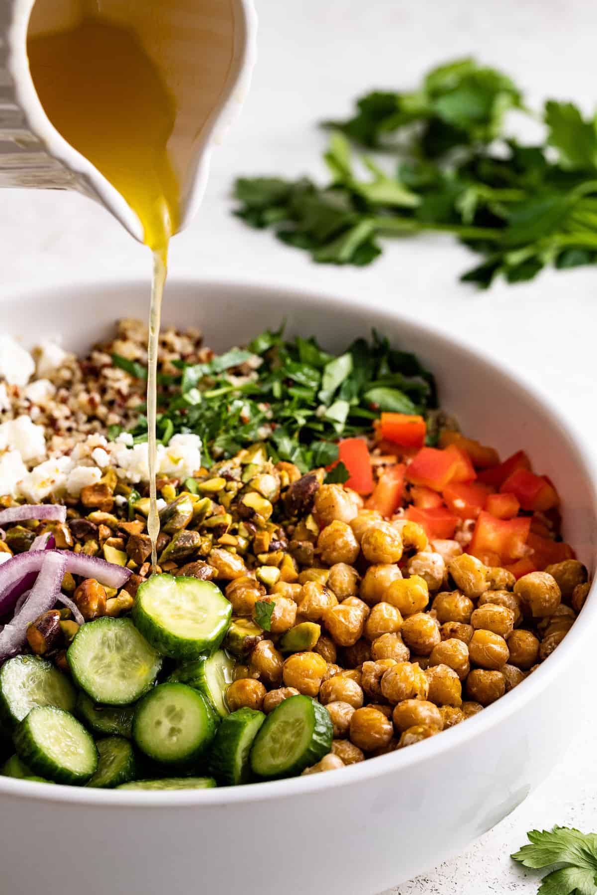 Pouring the dressing into the salad.