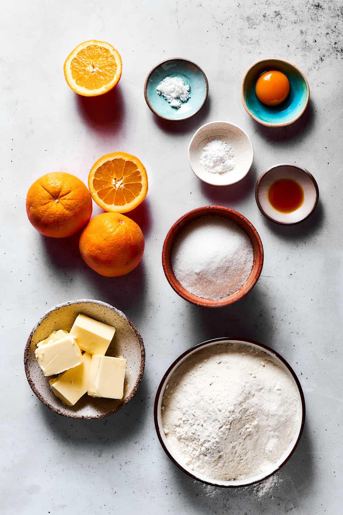 From top: Oranges, salt, orange zest, baking powder, vanilla, sugar, butter, flour.