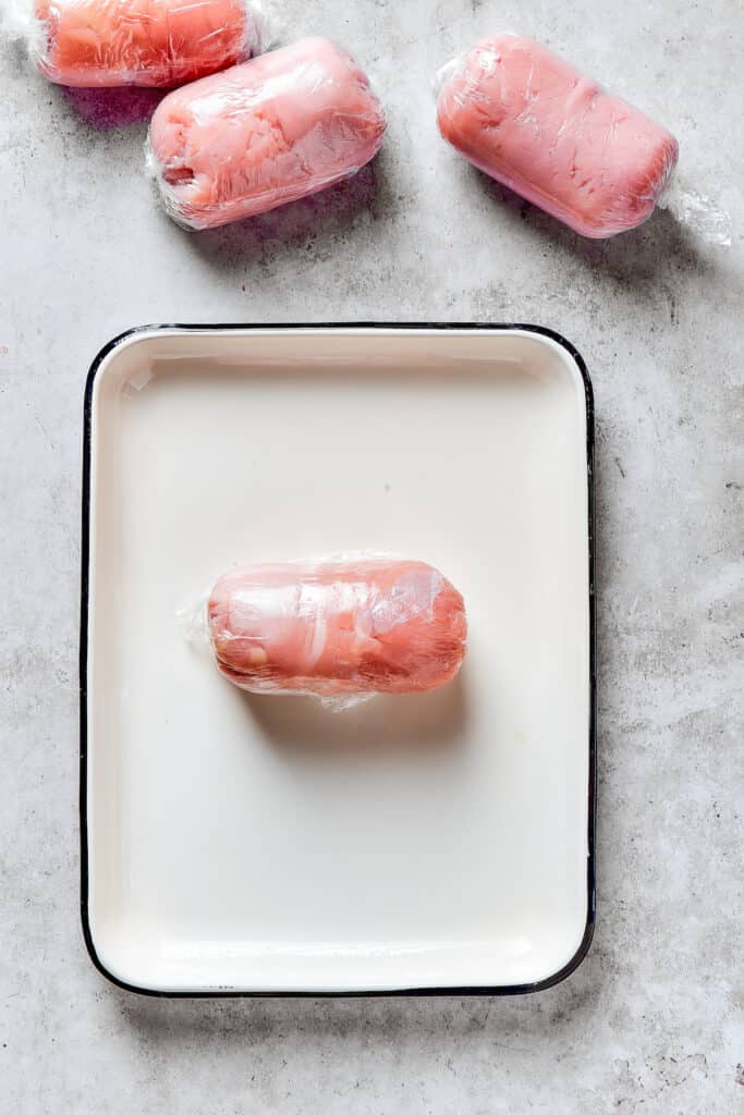 A rolled-up, uncooked chicken Kiev piece.