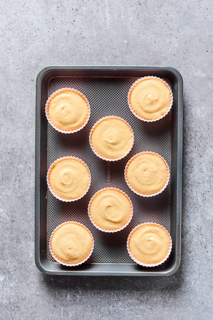 Unbaked cupcakes on a tray.
