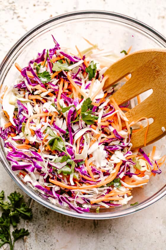 Asian cabbage slaw in a glass mixing bowl.