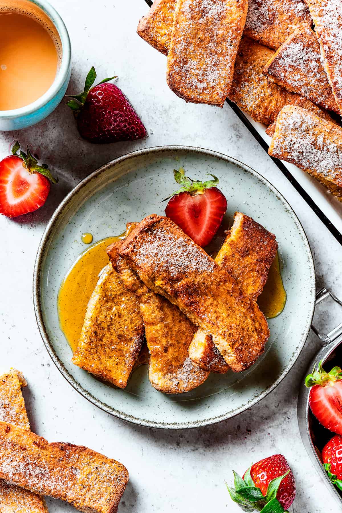 A strawberry-garnished plate of homemade French toast.