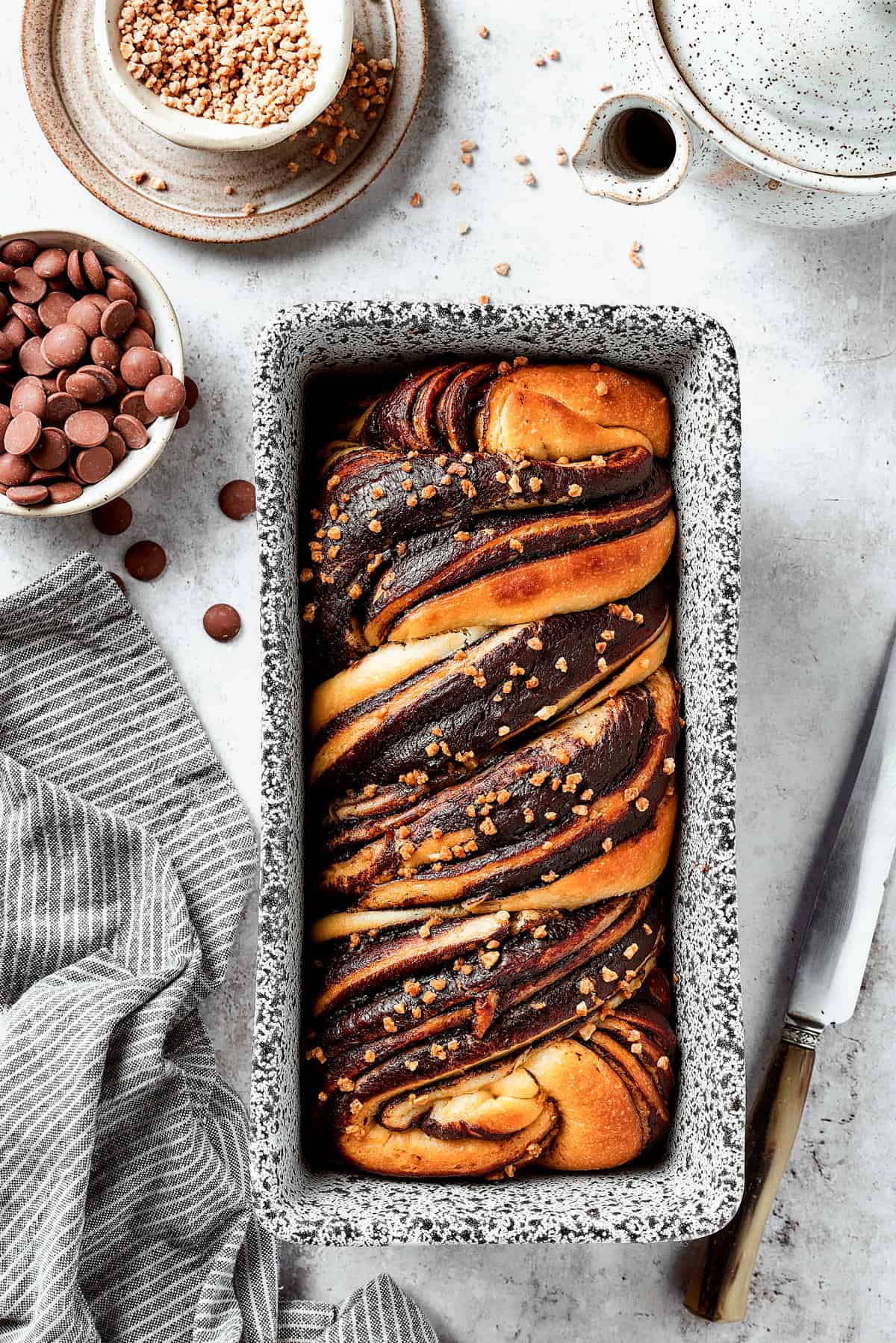 A baked chocolate babka in a loaf pan.