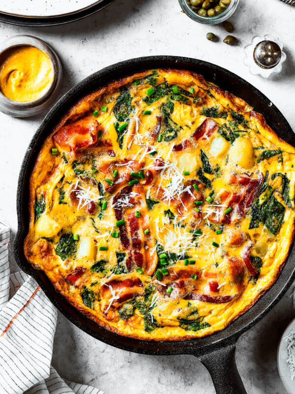 overhead shot of a fully-cooked frittata in a cast-iron skillet.