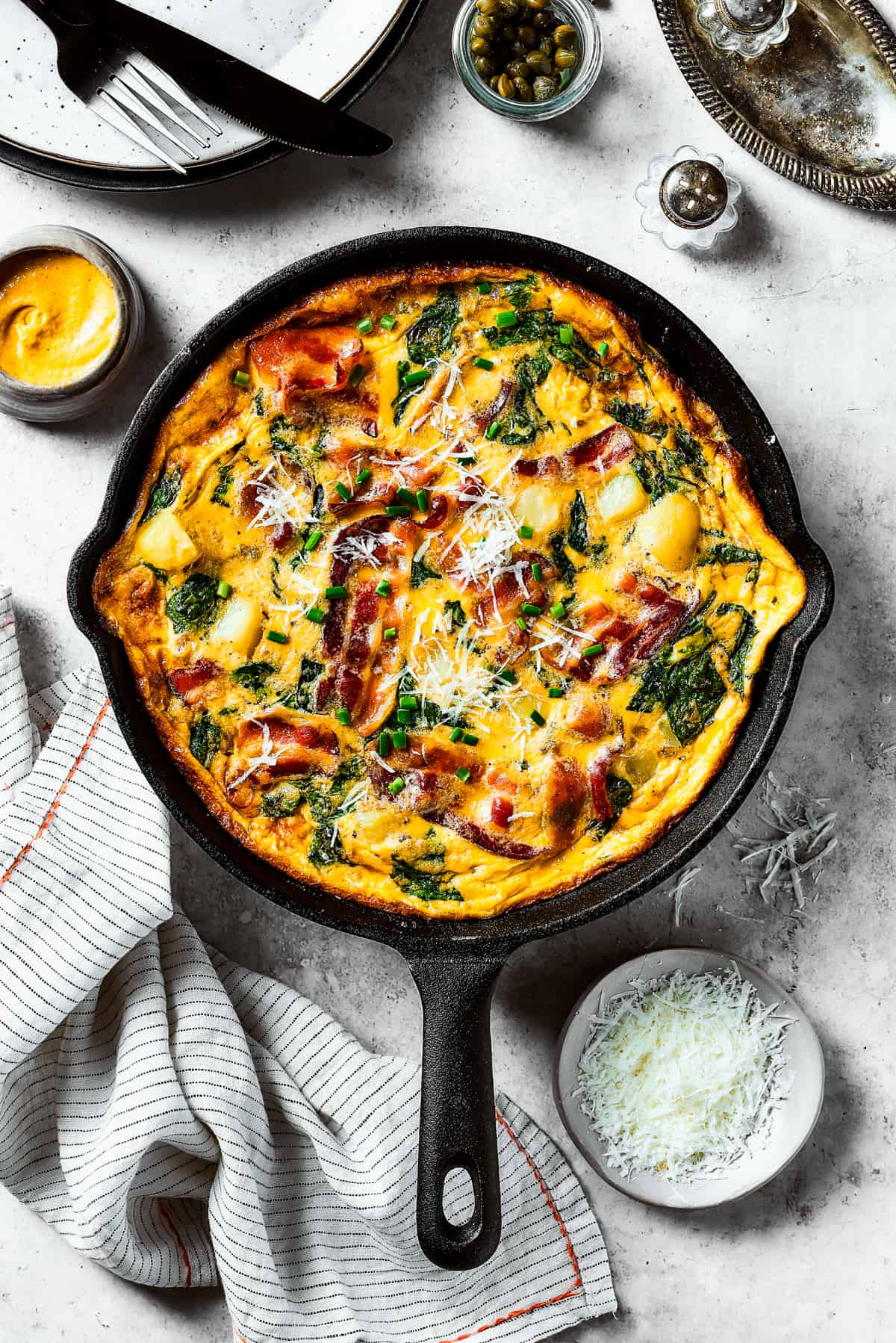 A fully-cooked frittata in a cast-iron skillet.