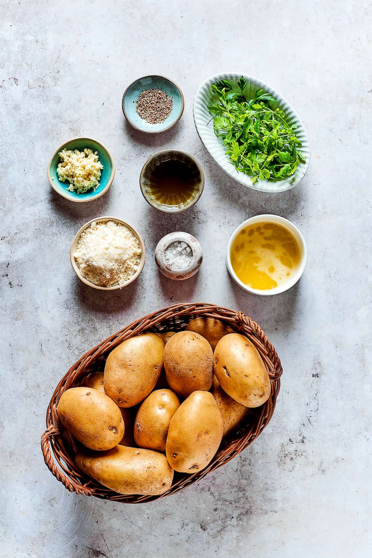 Ingredients for garlic fries, arranged in dishes on a work surface.