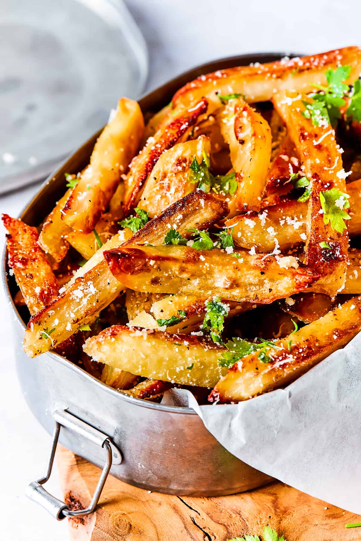 Seasoned parmesan garlic fries in a tin box.