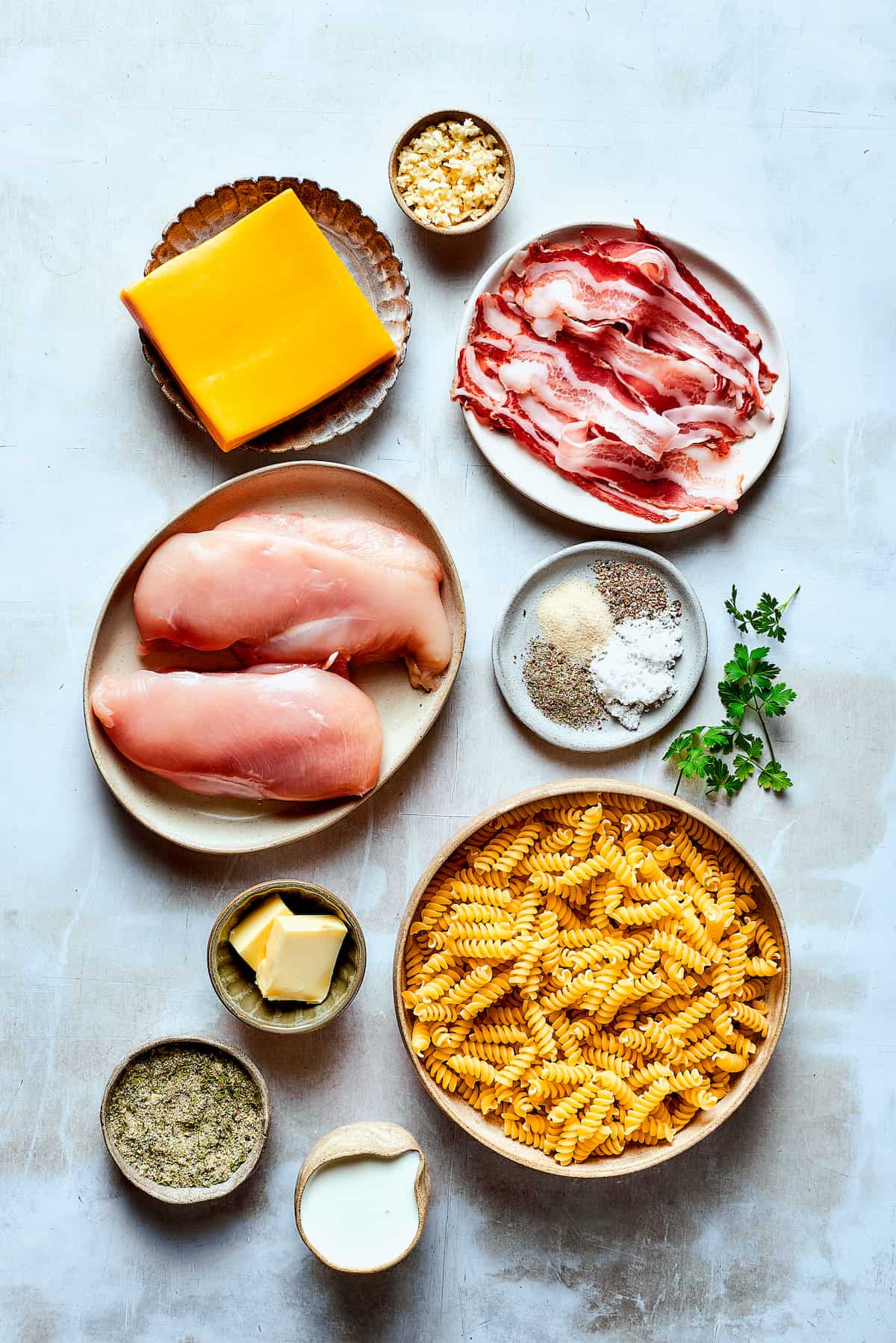 Ingredients for chicken bacon ranch pasta measured and arranged on a work surface.
