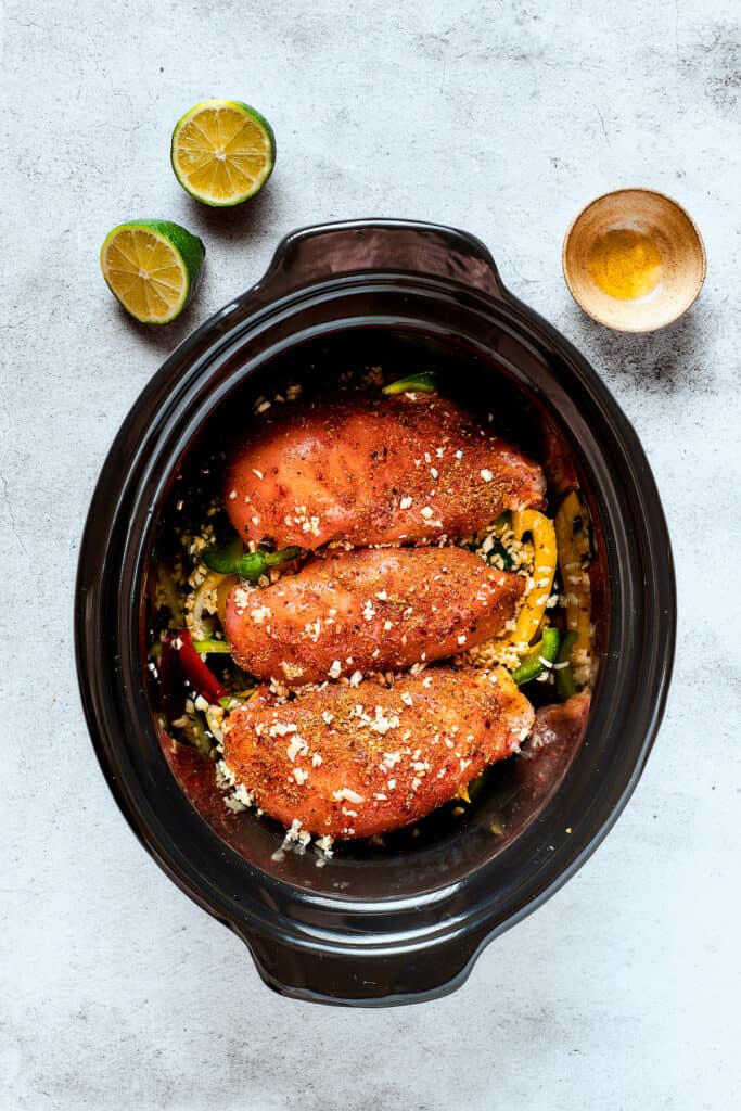 Fajita chicken in a crockpot with peppers.
