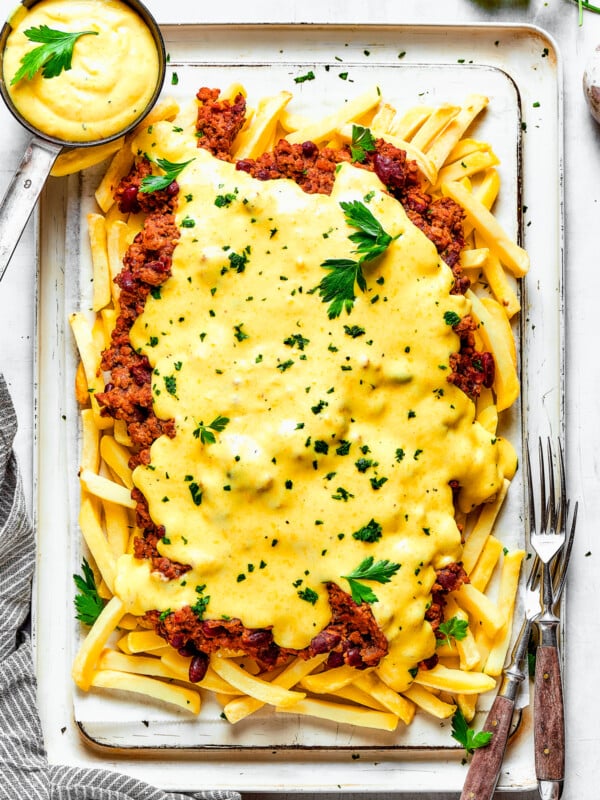 Cheese sauce poured over a batch of chili fries.