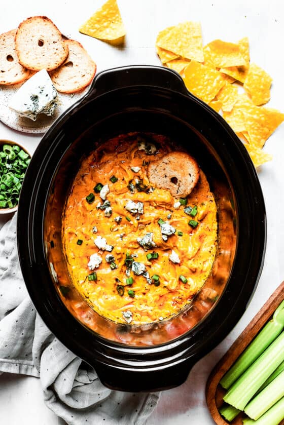 A slow cooker insert full of cheesy dip.