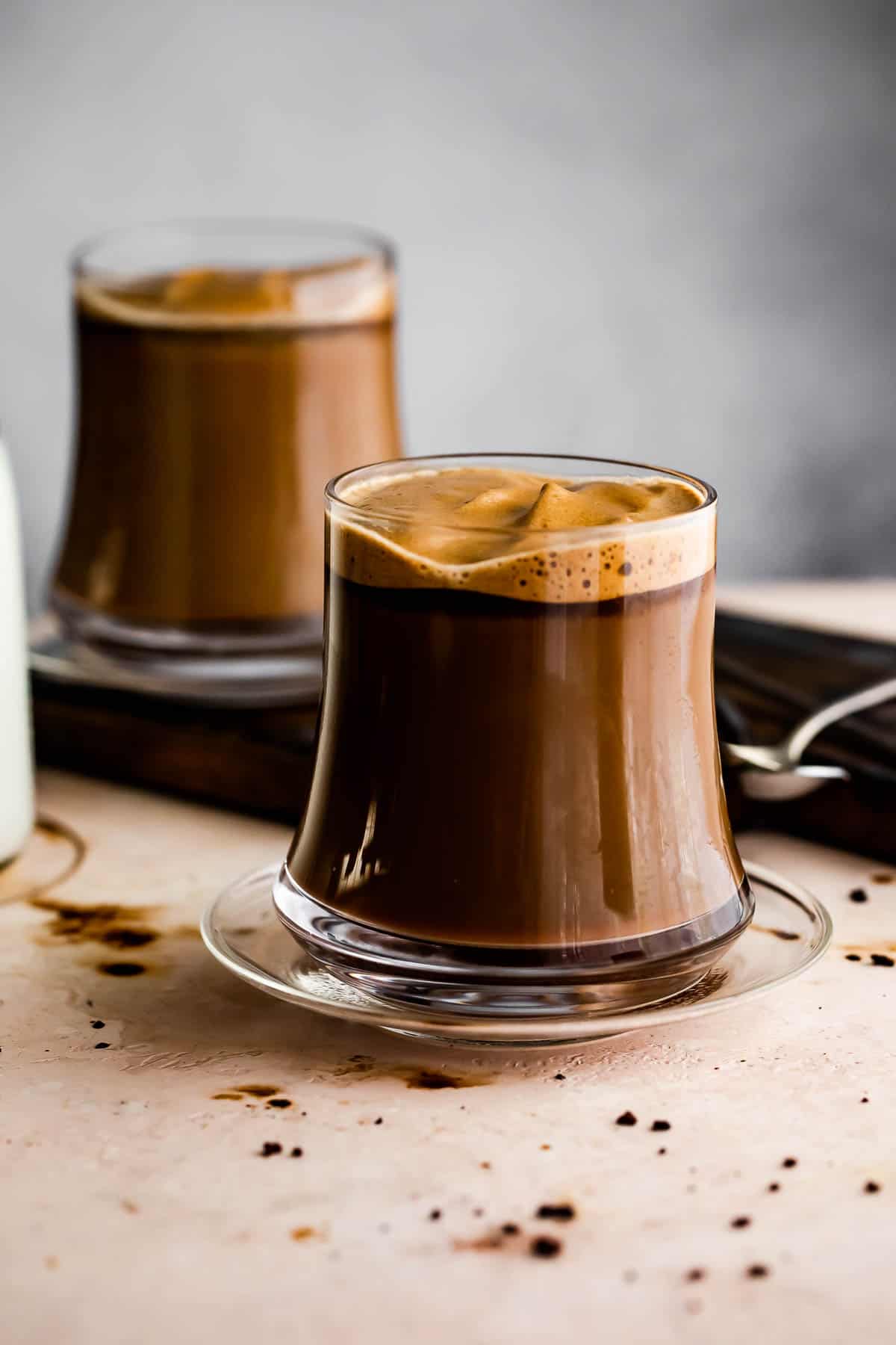 Image of two glass coffee mugs filled with coffee.