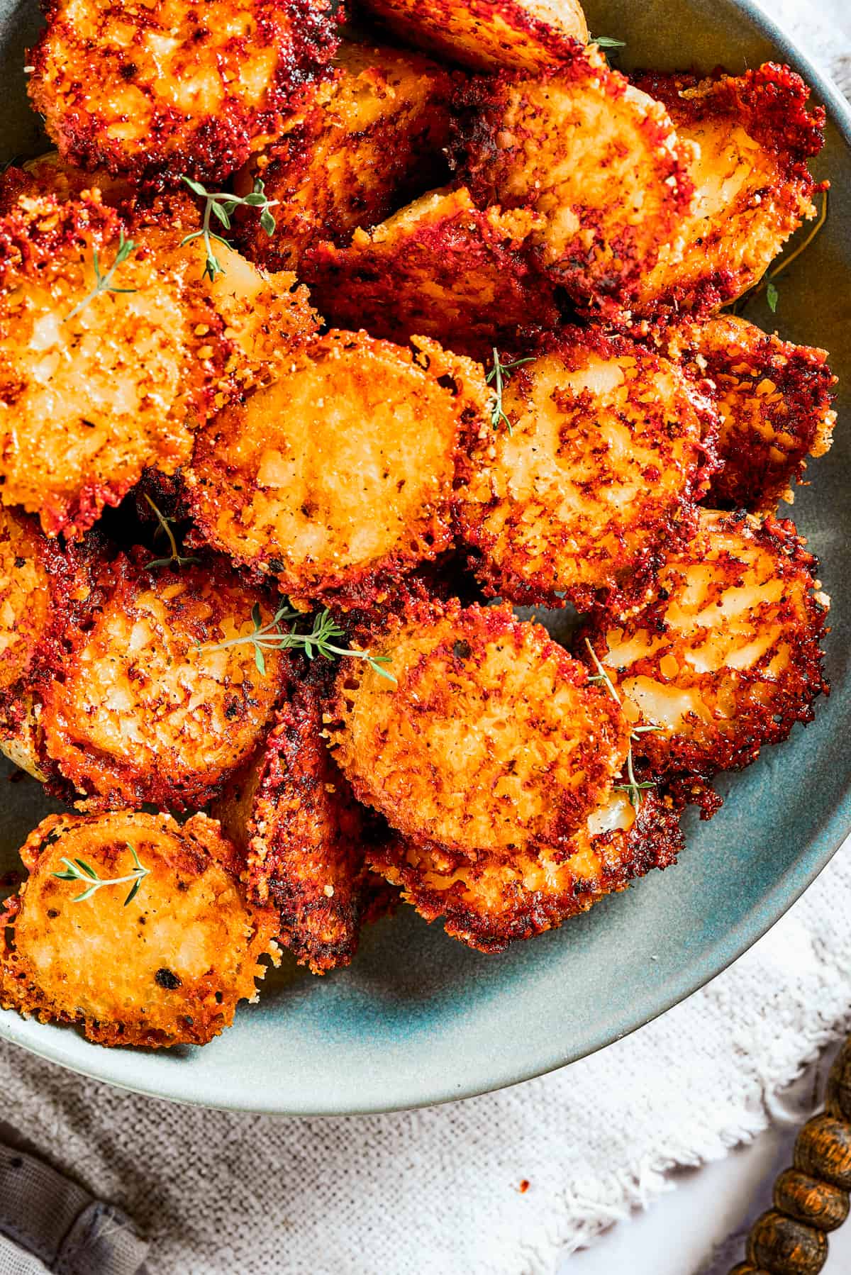 Close-up of parmesan-crusted potatoes in a bowl.
