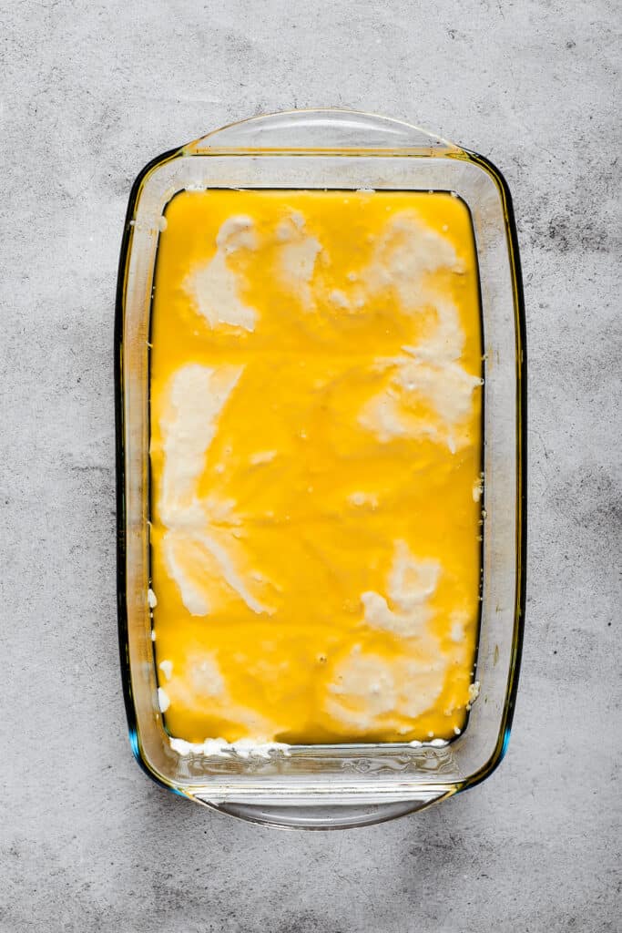 Biscuit dough in a baking dish full of butter