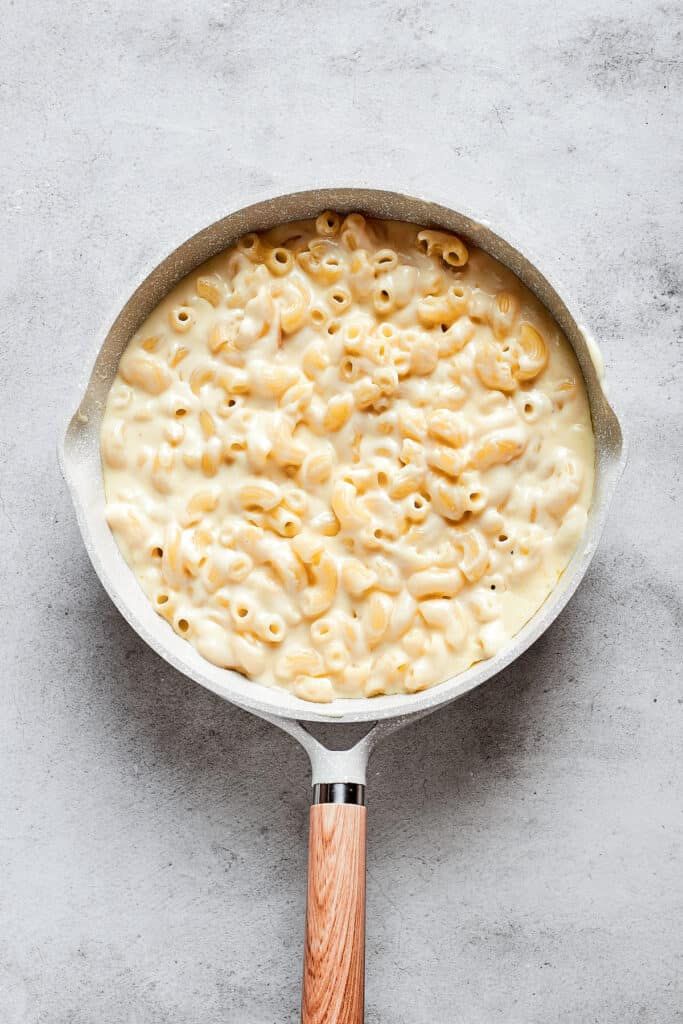 A sauce pan full of mac and cheese.