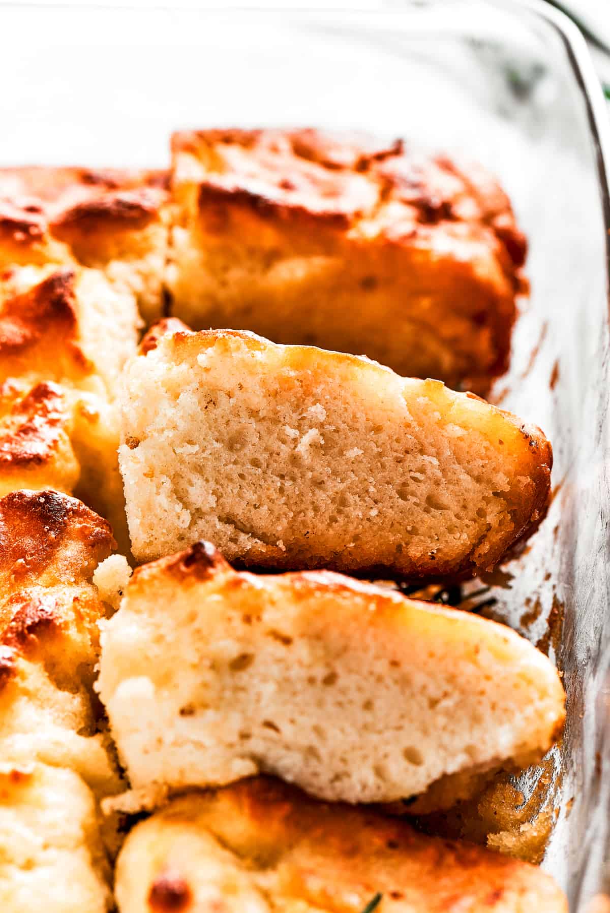 A pan with butter swim biscuits, with a few cut out and stacked on each other.