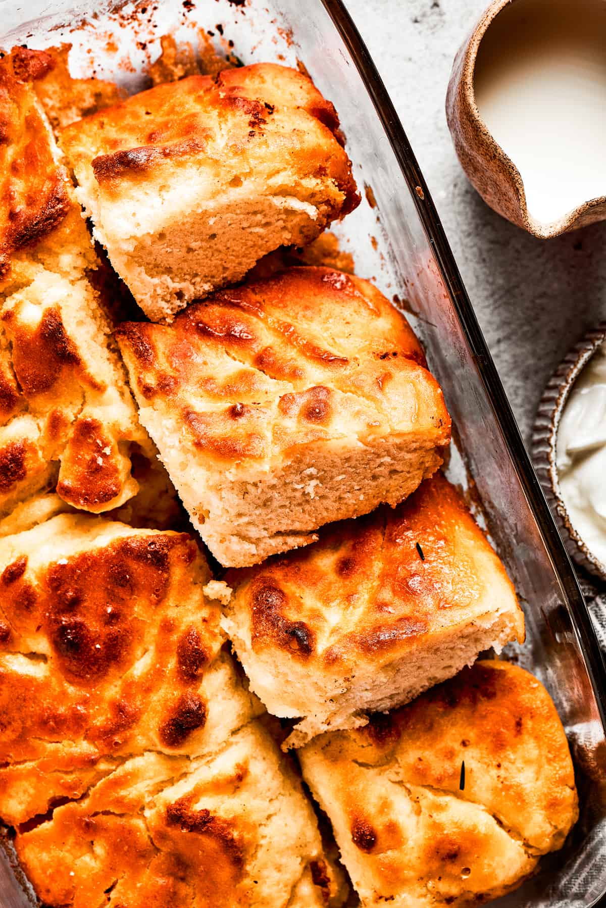 A pan with butter swim biscuits, with a few cut out and stacked on each other.