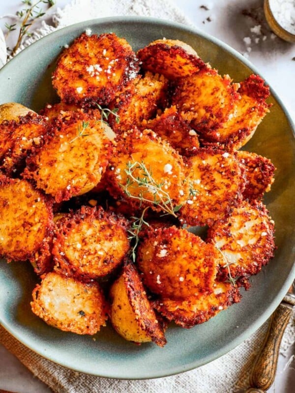 Overhead image of parmesan-crusted potatoes in a bowl.