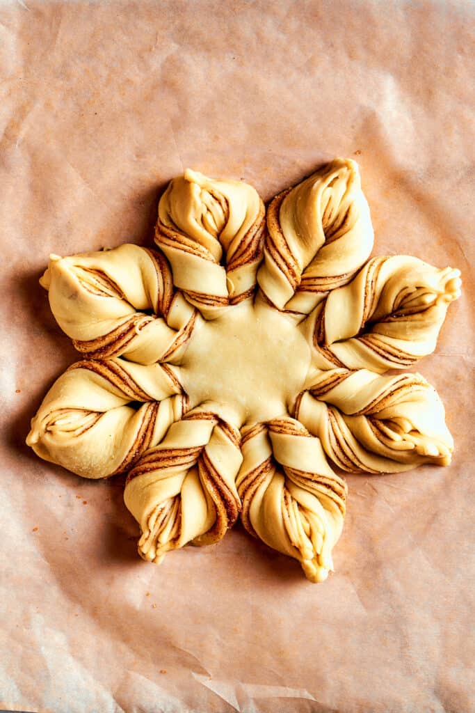 Overhead view of a fully assembled star bread before being baked.