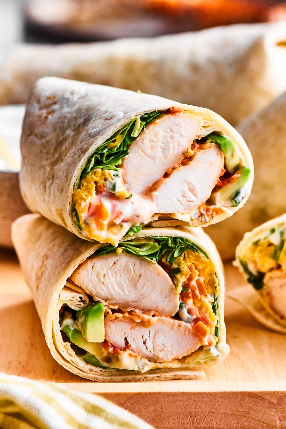 A cut buffalo chicken wrap shows the interior of chicken and vegetables.