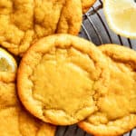 Close-up shot of several lemon cookies arranged on a round wire rack.