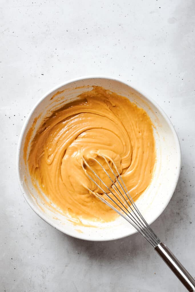 A whisk incorporates all of the ingredients into the batter to make blonde brownies.