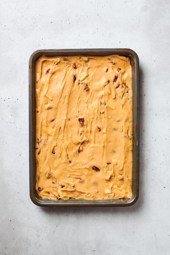 Blonde brownies batter is spread into a baking pan.