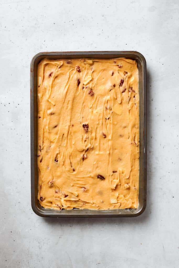 Blonde brownies batter is spread into a baking pan.