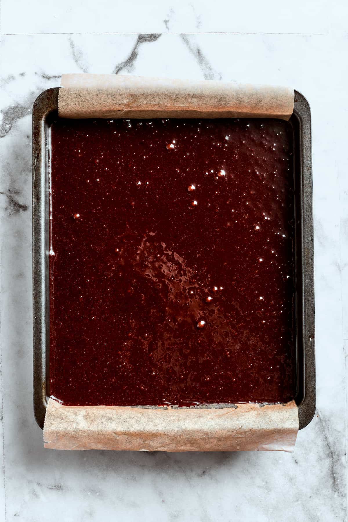 Pecan Praline Brownie Squares 6 Smooth brownie batter is carefully spread into a prepared baking pan.