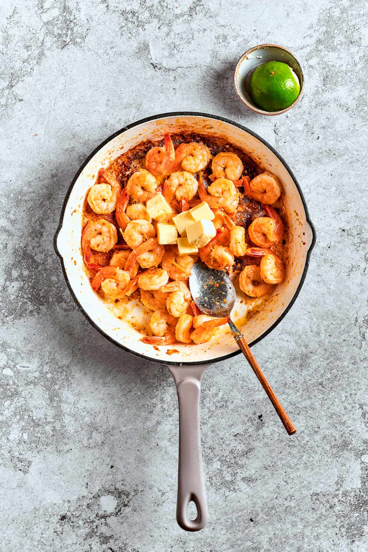 Sautéing the shrimp to perfection. Seasoned shrimp sizzling in a hot skillet, beginning to turn opaque and develop a delicious crust.