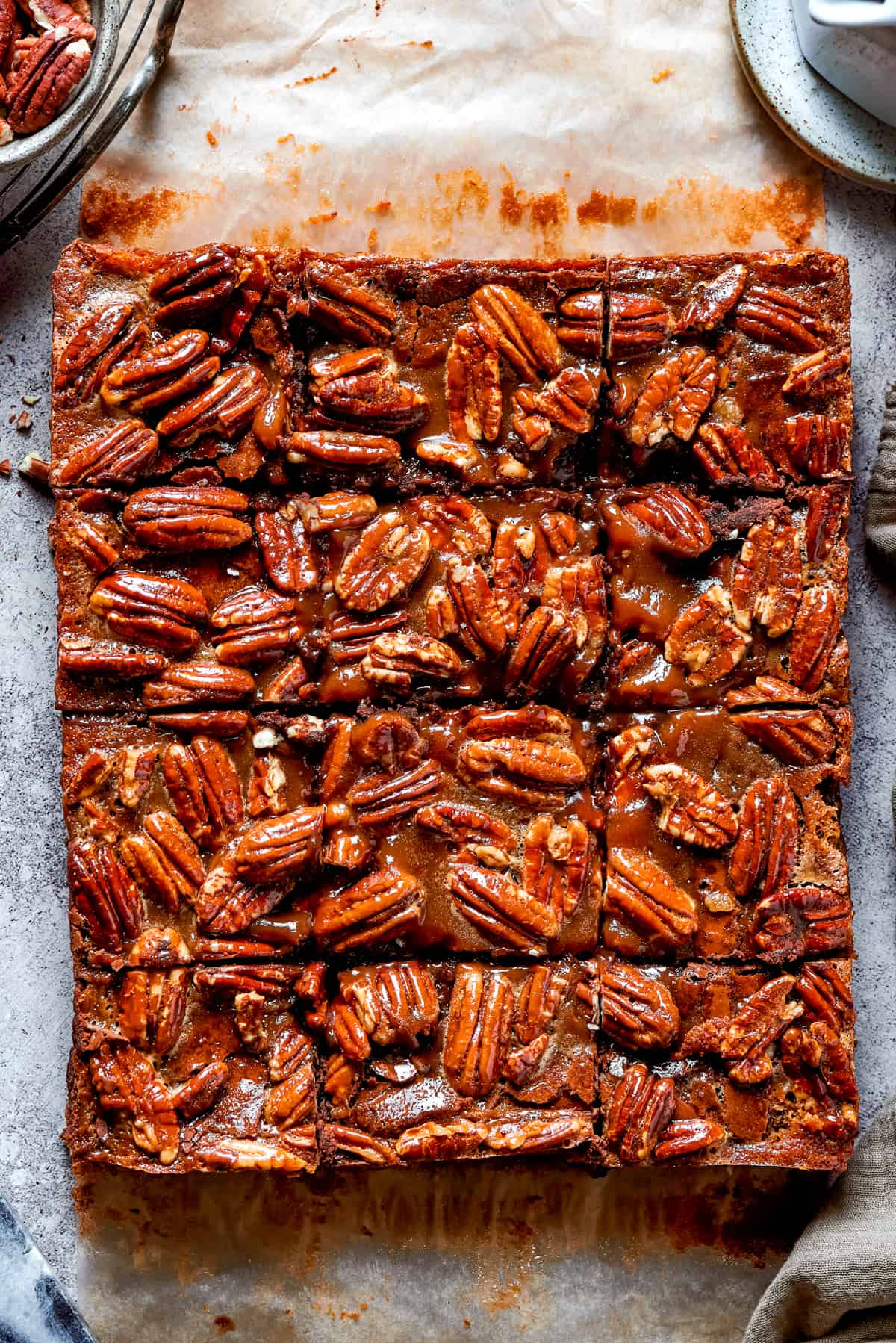 Overhead shot of pecan-topped cake cut into squares.