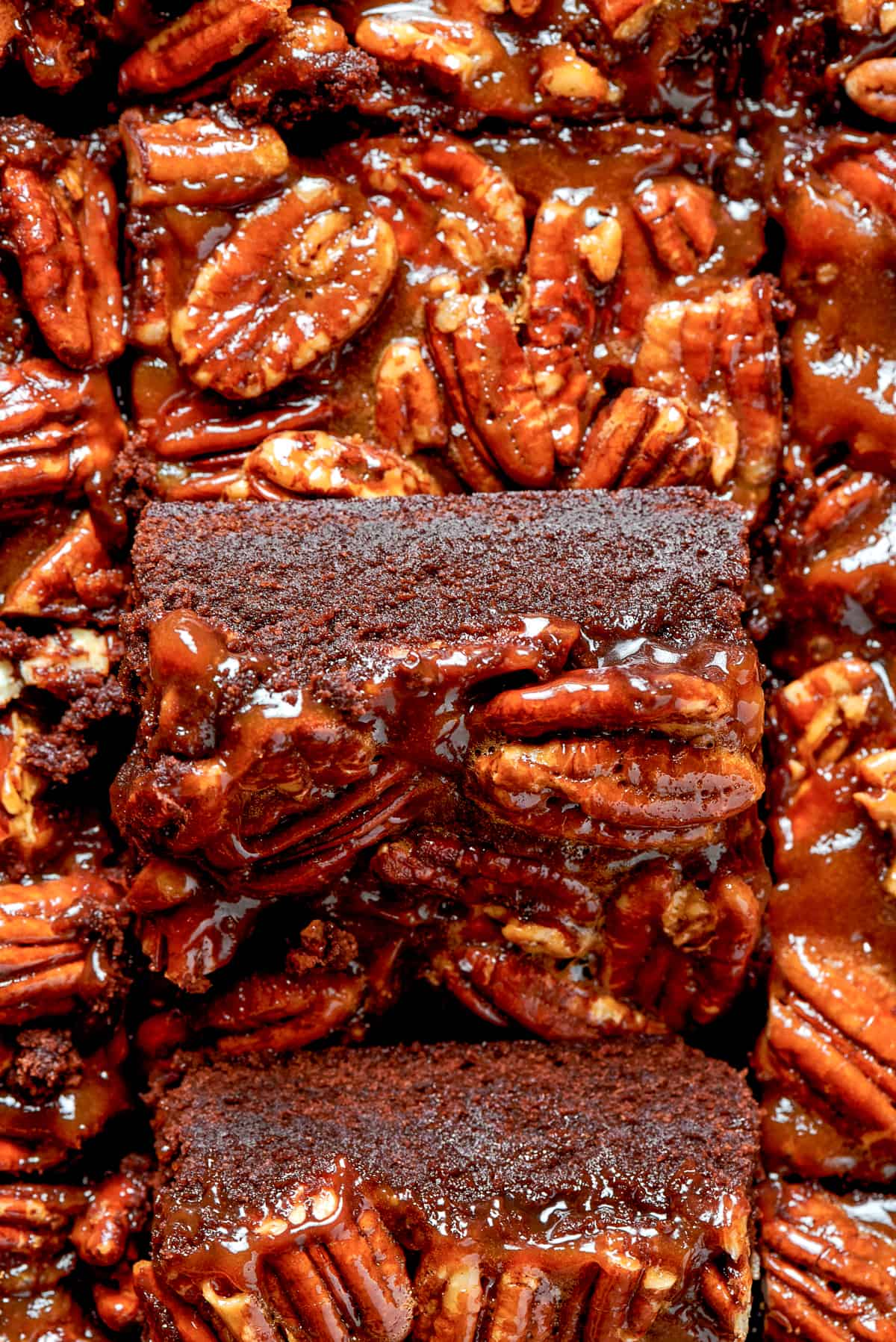 Up close shot of a brownie square topped with pecans.