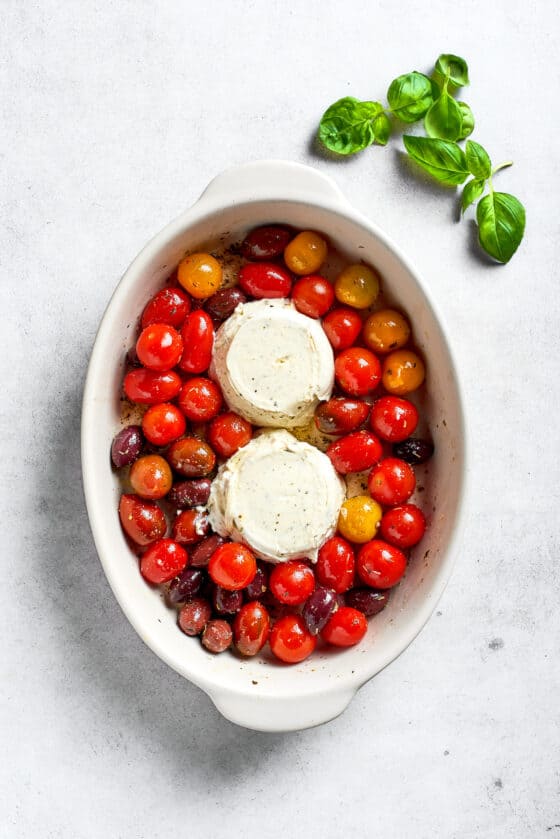Two blocks of Boursin cheese are added to the tomatoes.