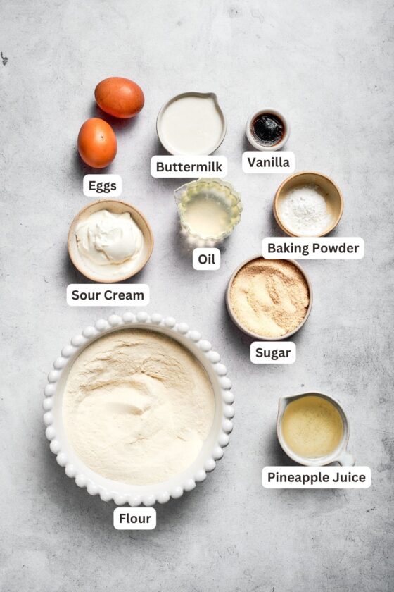 Ingredients for pineapple cake are shown: flour, pineapple juice, baking powder, sugar, oil, vanilla, buttermilk, sour cream, eggs.