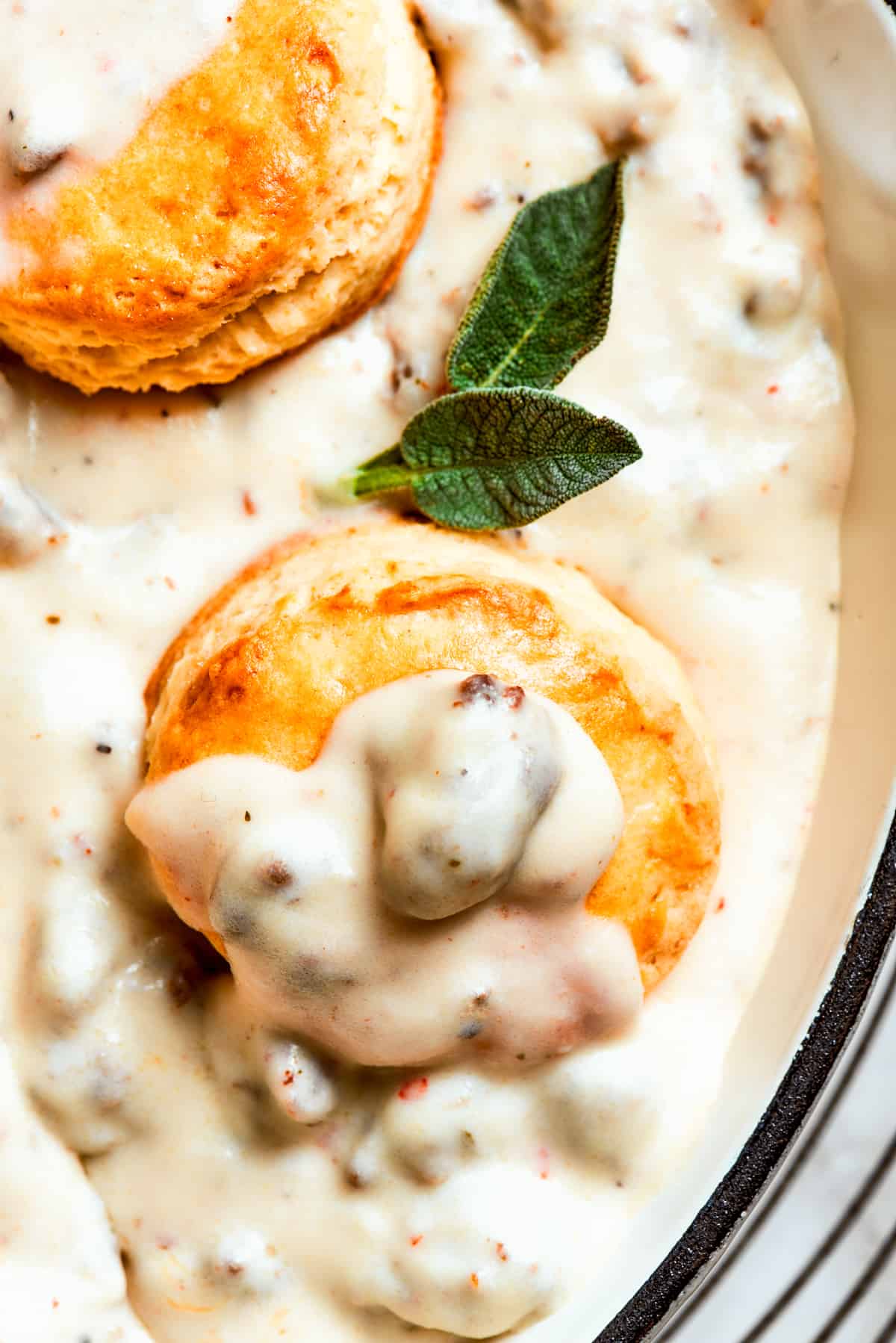 Close-up image of biscuits topped with sausage gravy.